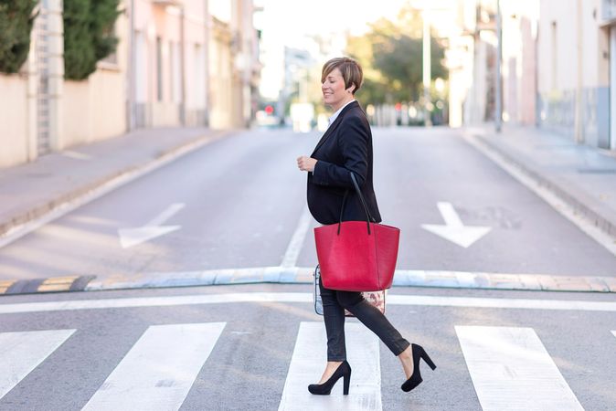 Well dressed business woman crossing the street