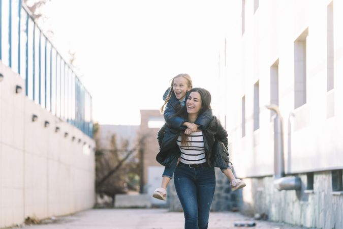 Woman doing young sister piggyback