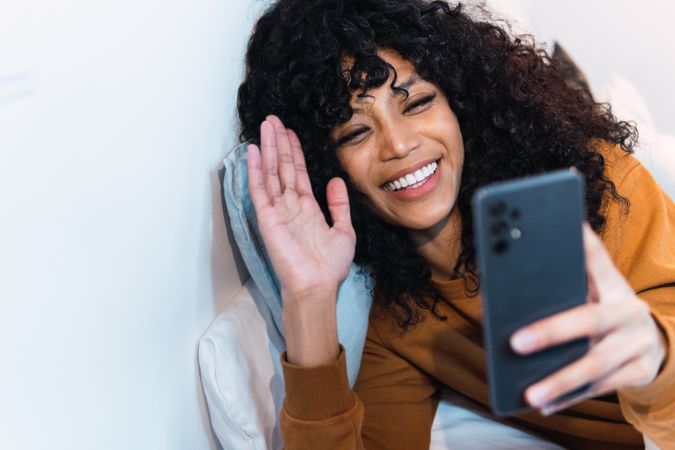 Cheerful Black woman talking on video call
