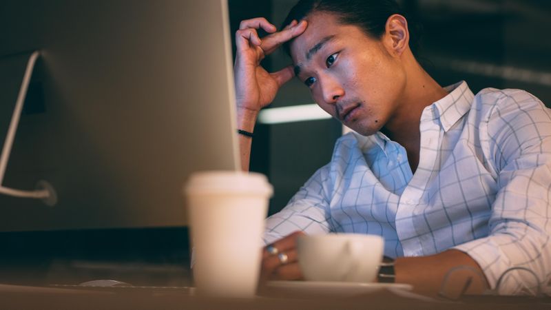 Entrepreneur working late night in office looking stressed out