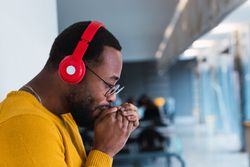 Black man listening to music in headphones