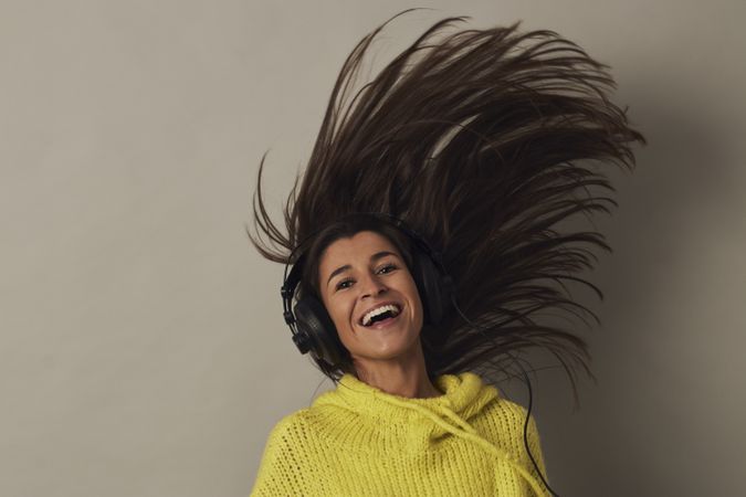 Shocked young woman listening to music in studio