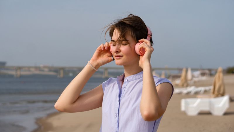 Woman listening to music in headphones outdoors