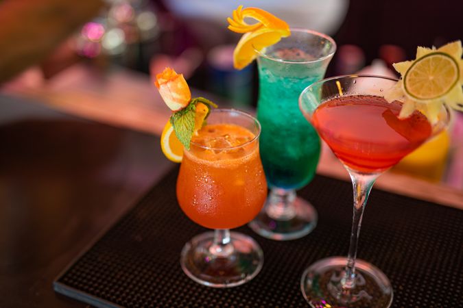Landscape shot of three tropical cocktails with garnishes