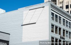 Painted square on side of blue brick building for mockup 47BRk5