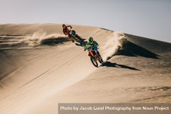 Motocross racers racing over off-road terrain 0vndL0