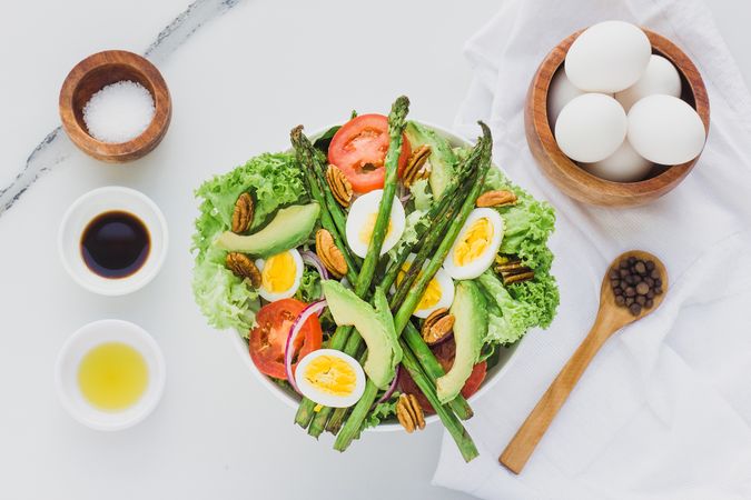Salad with asparagus eggs avocados tomatoes and walnuts