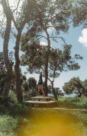 Man training yoga on meadow