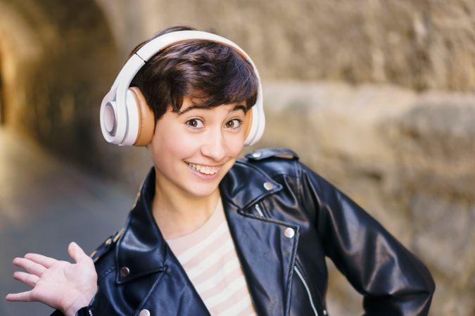 A Stylish Young Woman Wearing Headphones, Captured in an Urban Setting Full of Life