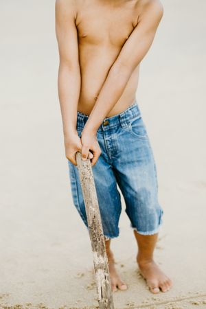 Crop Black boy playing on beach