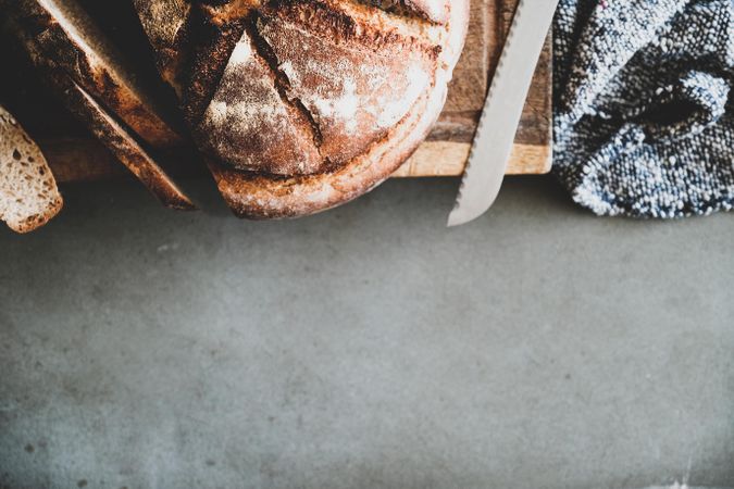 Freshly baked sourdough bread loaf, sliced, horizontal composition, copy space