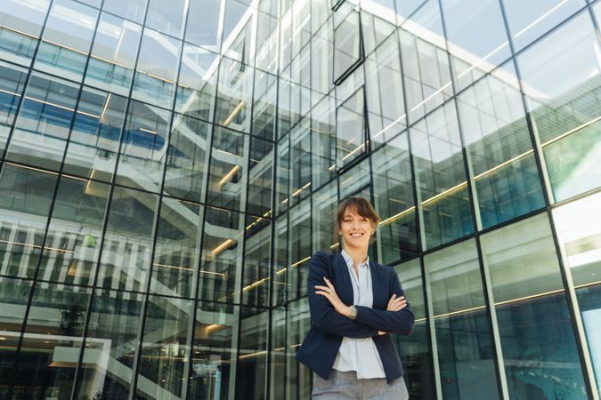 Confident businesswoman outside modern building