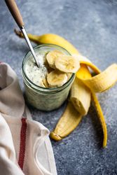 Healthy breakfast with chia seeds and banana slices on counter with copy space