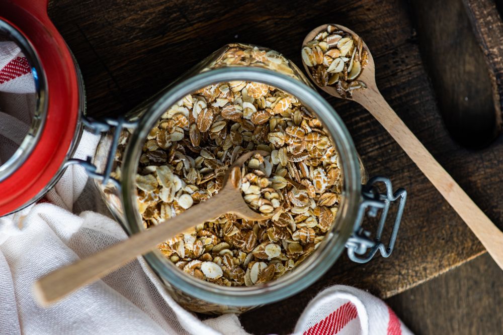 Top view of jar of dry oats with spoons