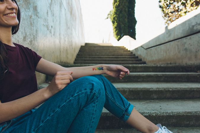 Woman with gay pride tattoo.