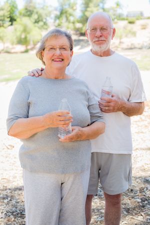 Happy Healthy Mature Couple with Water Bottles