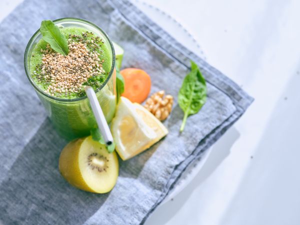 Delicious smoothie with fruits on towel