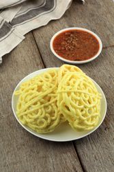 Crispy kerupuk mie banjur sambel oncom served with sauce on wooden table
