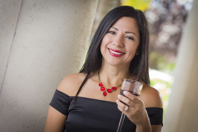 Hispanic Woman Portrait Outside Enjoying Wine