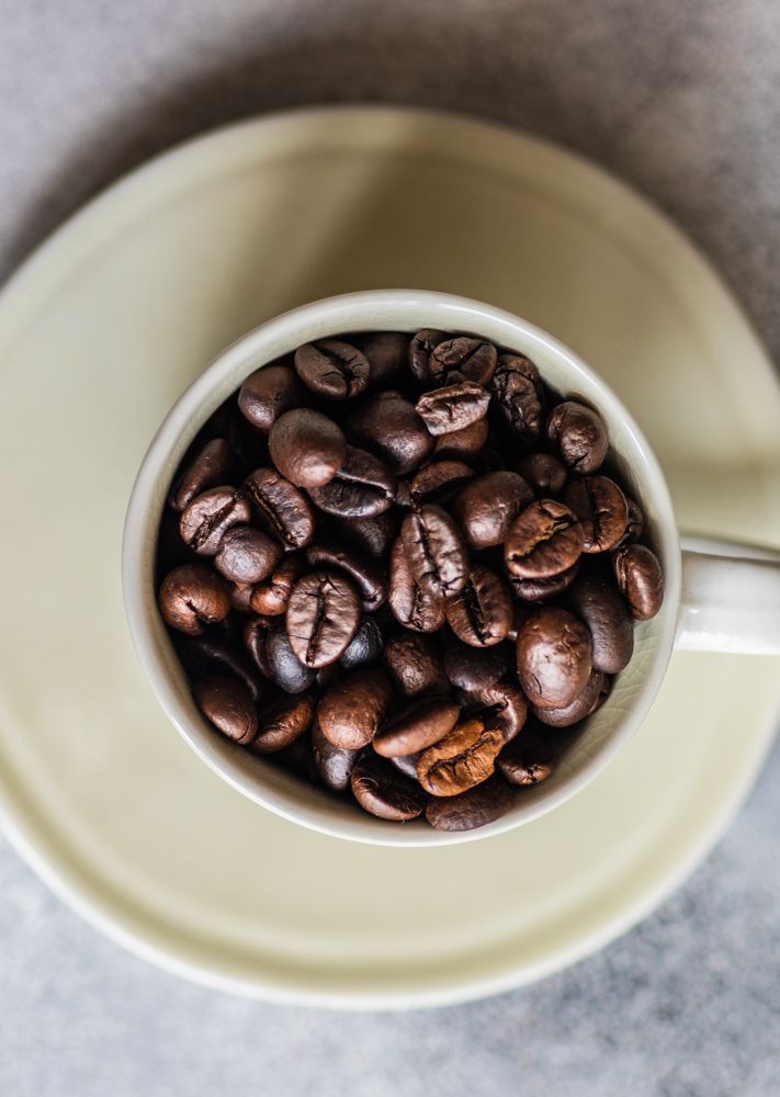 Top view close up of coffee beans in cup