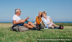 Happy family on outdoor picnic with ukulele bxJXa5