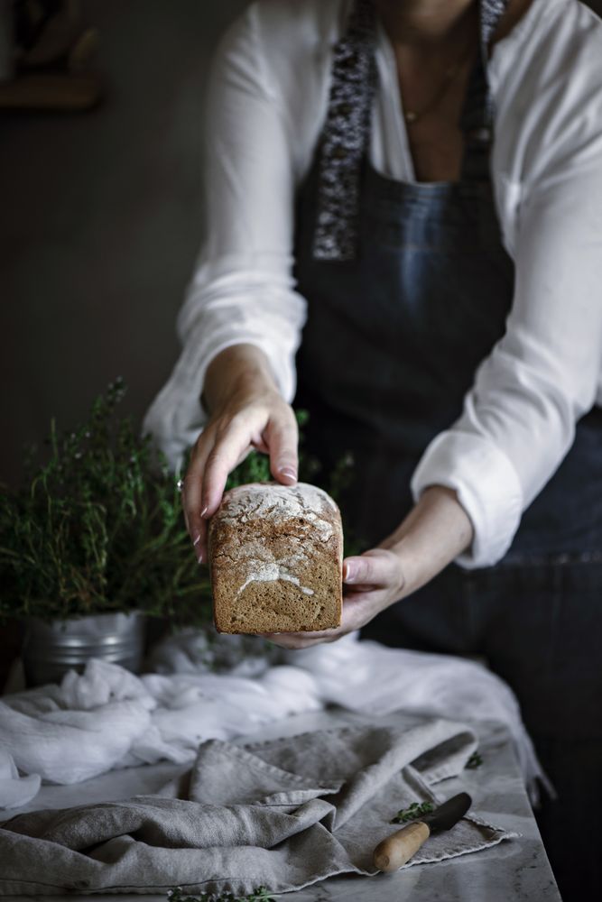 Fresh bread on napkin near tomatoes jam