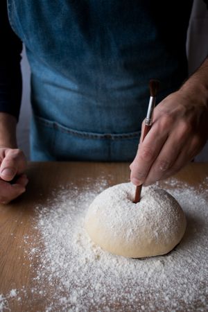 Crop man preparing Rosca de Reyes