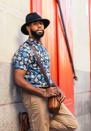 Portrait of a stylish Black man in hat and alternative outfit