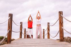 Couple practicing martial arts on lumber path