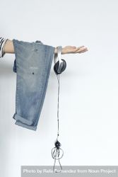 Jeans and headphones hanging off outstretched arm, vertical 42ykd5