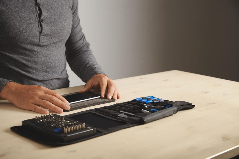 Man with smart phone and tools
