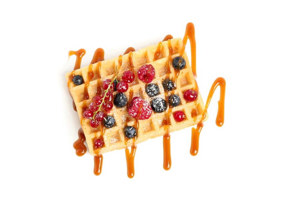 Waffle under caramel topping isolated on blank background