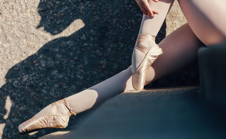 Close up of ballet dancer sitting outdoors