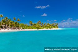 Wide shot of clear blue water and reclining chairs on the beach, landscape 0VG635