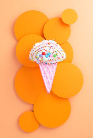 Cute ice cream cone toy on orange background