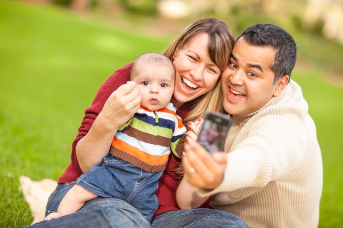 Happy Parents and Baby Boy Taking Self Portraits at the Park