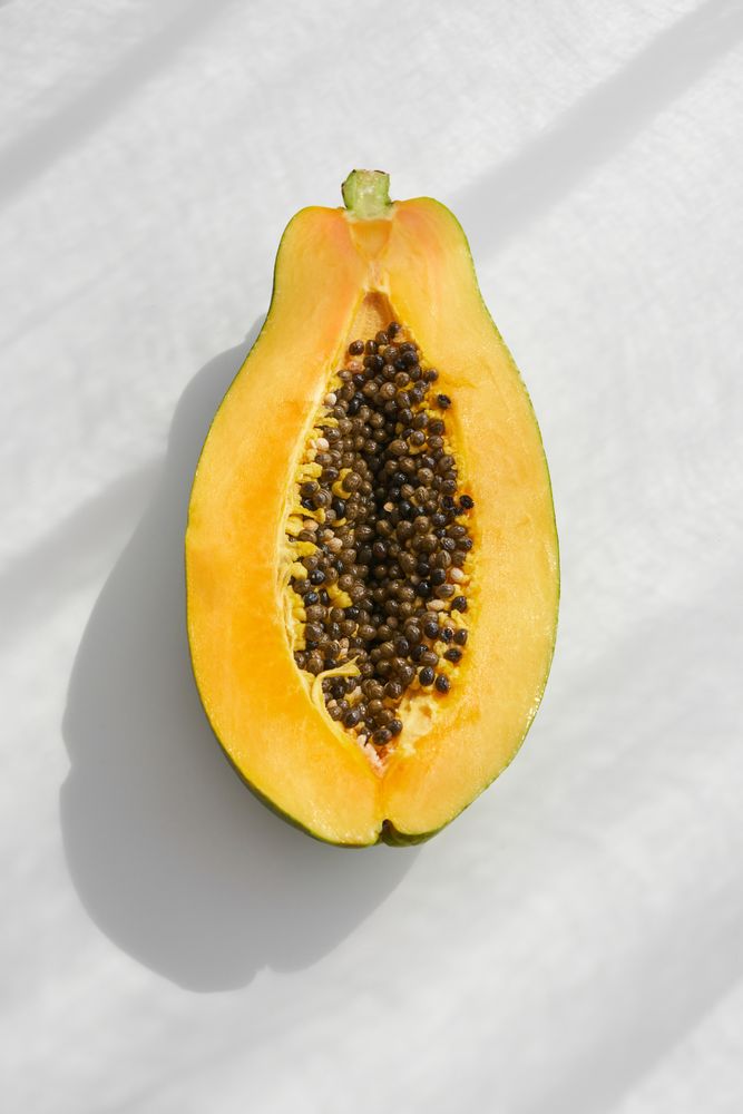Half of ripe papaya on table