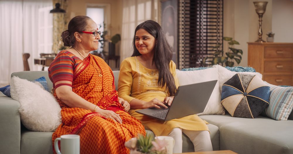 Excited Indian Mother and Daughter Online Shopping for Deals
