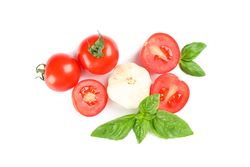 Fresh cherry tomatoes with basil and garlic isolated on blank background, top view. Ripe vegetables