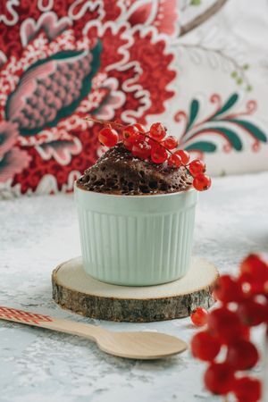 Chocolate cake in the cup with currants and sugar glass.