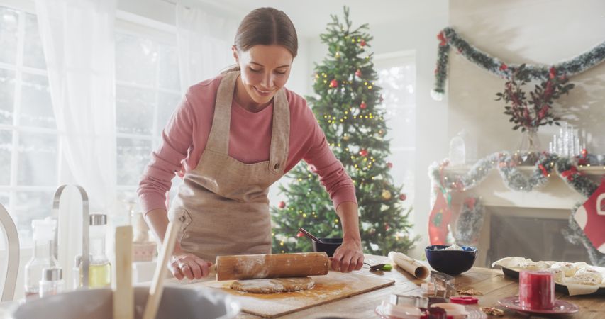 Young Woman Preparing the Dough to Make Gingerbread on Christmas.
