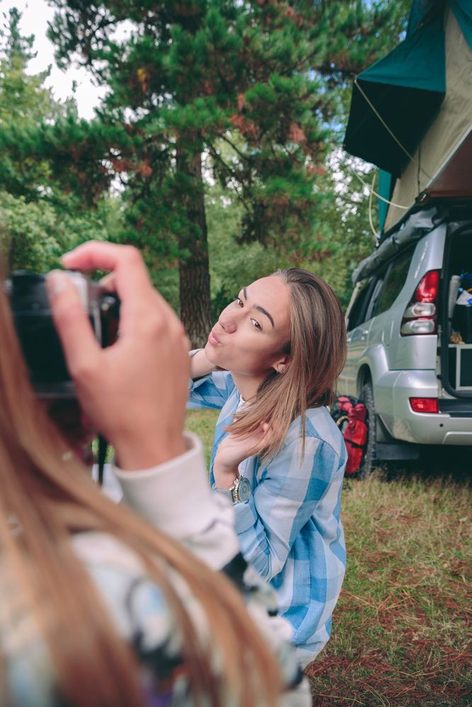 Female hand taking photo to woman with 4x4 on background