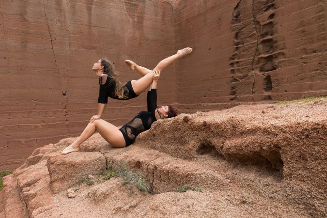 Young women exercising on stones