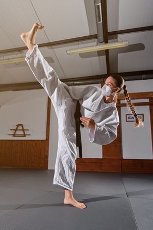 Female practicing punch in modern room