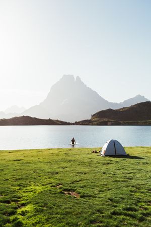 Man bathing near the tent in the mountain