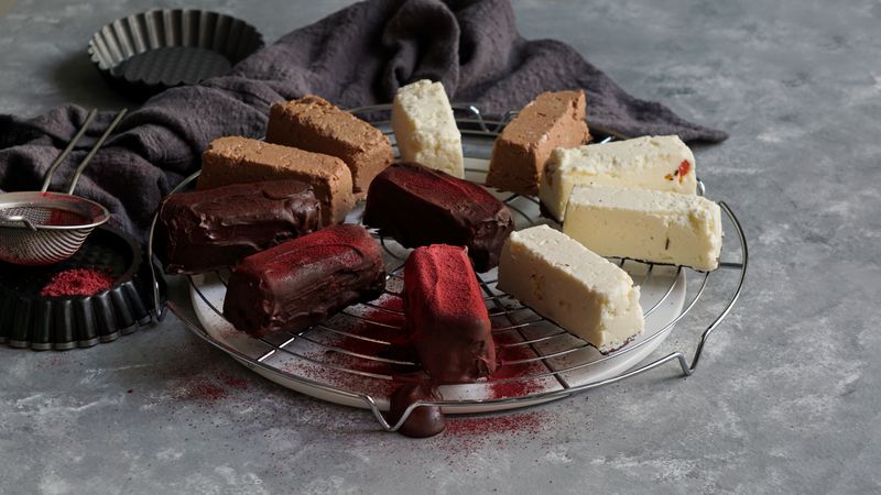 Chocolate and strawberry cakes near bows with ingredients