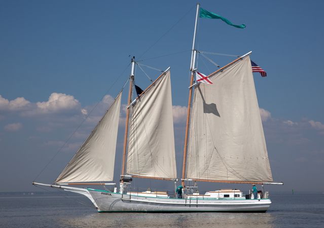 Joshua The Classic Wooden Schooner floating on calm waters in Mobile Bay, Alabama