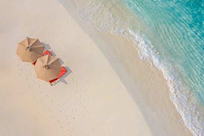 Overhead shot of parasols and reclining chairs on the beach, landscape