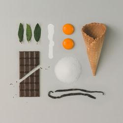 Deconstructed ice cream with egg yokes, mint, chocolate, vanilla beans, sugar, cream and waffle cone