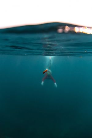 Woman diving in blue water